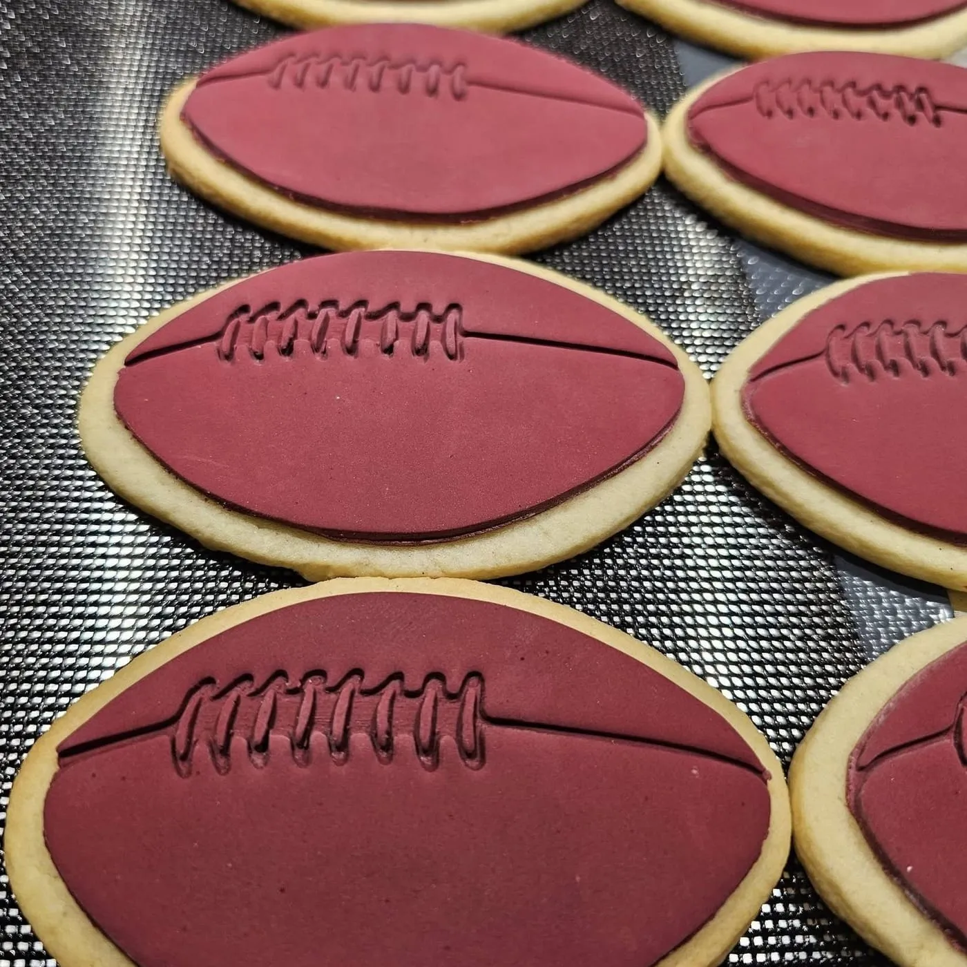 Maroon and brown footballs